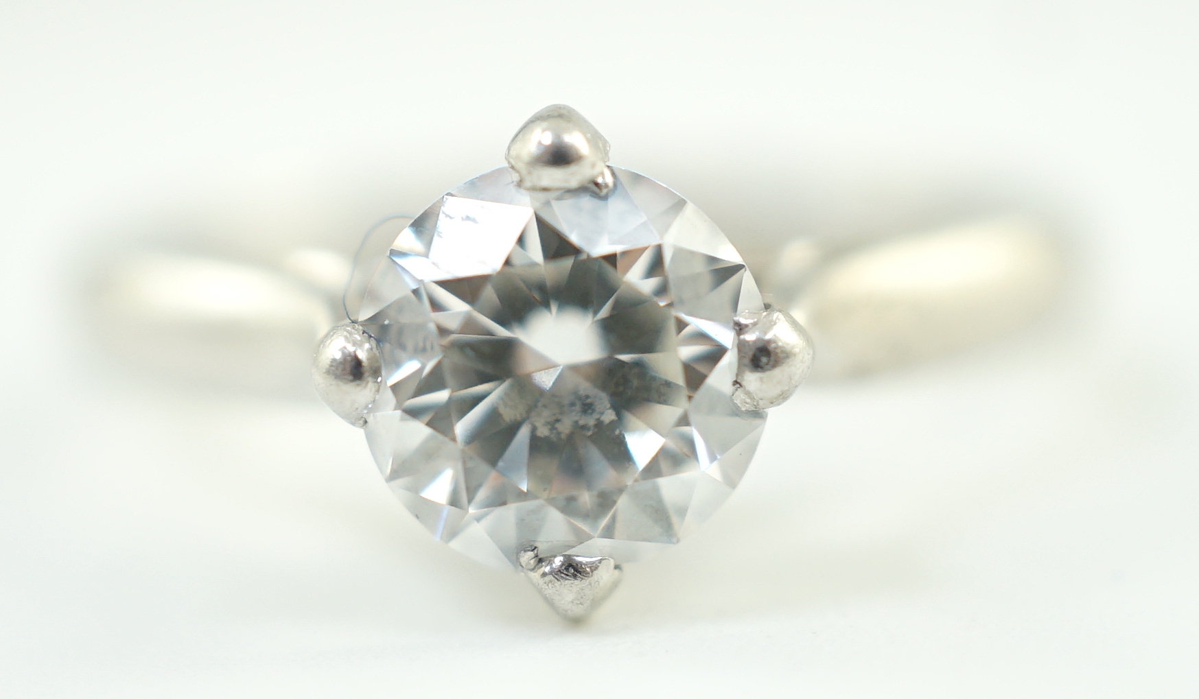 A modern platinum and solitaire diamond set ring